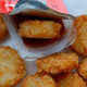 Chick-fil-A hash browns being dipped in ketchup